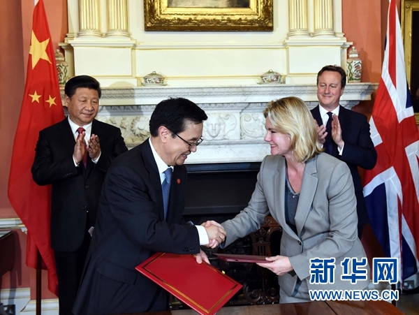 10月21日，國家主席習近平在倫敦唐寧街首相府同英國首相卡梅倫舉行會談。這是會談結束后，兩國領導人共同見證雙邊合作文件的簽署。新華社記者 饒愛民 攝 